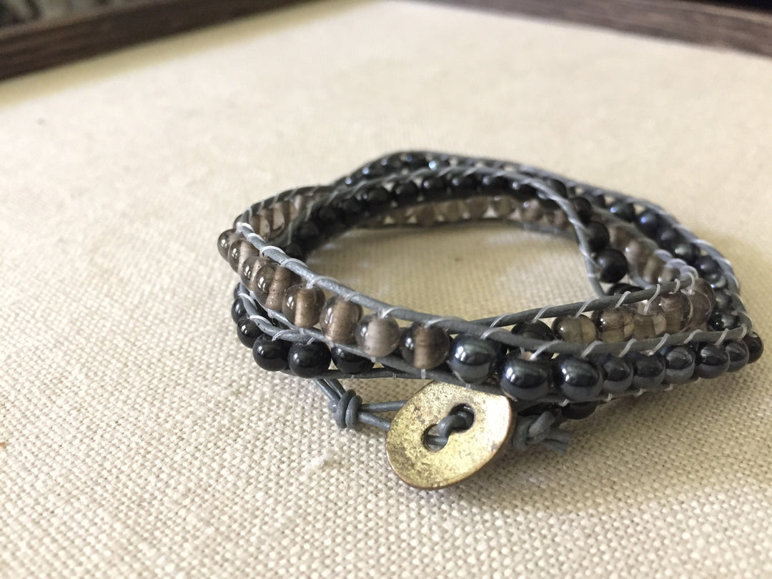 Smoky gray, hematite and onyx beaded wrap bracelet with gray cord and copper hammered button closure