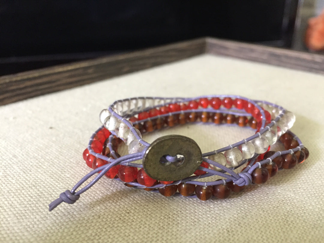 Brown, red and frosty white beaded wrap bracelet with lavendar cord and hammered copper closure