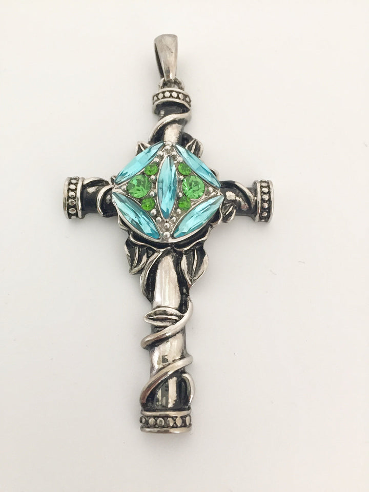 Cross pendant shown with snap